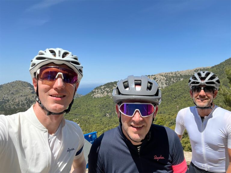 Three road cyclists smiling having cycled to the top of Sa Calobra Mallorca