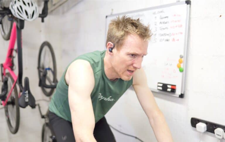 a person sweating hard while on an indoor turbo bike