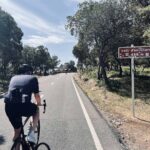 a cyclist riding up hills