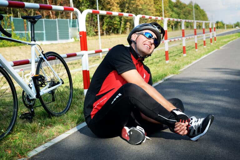 A man sitting on the side of the road.