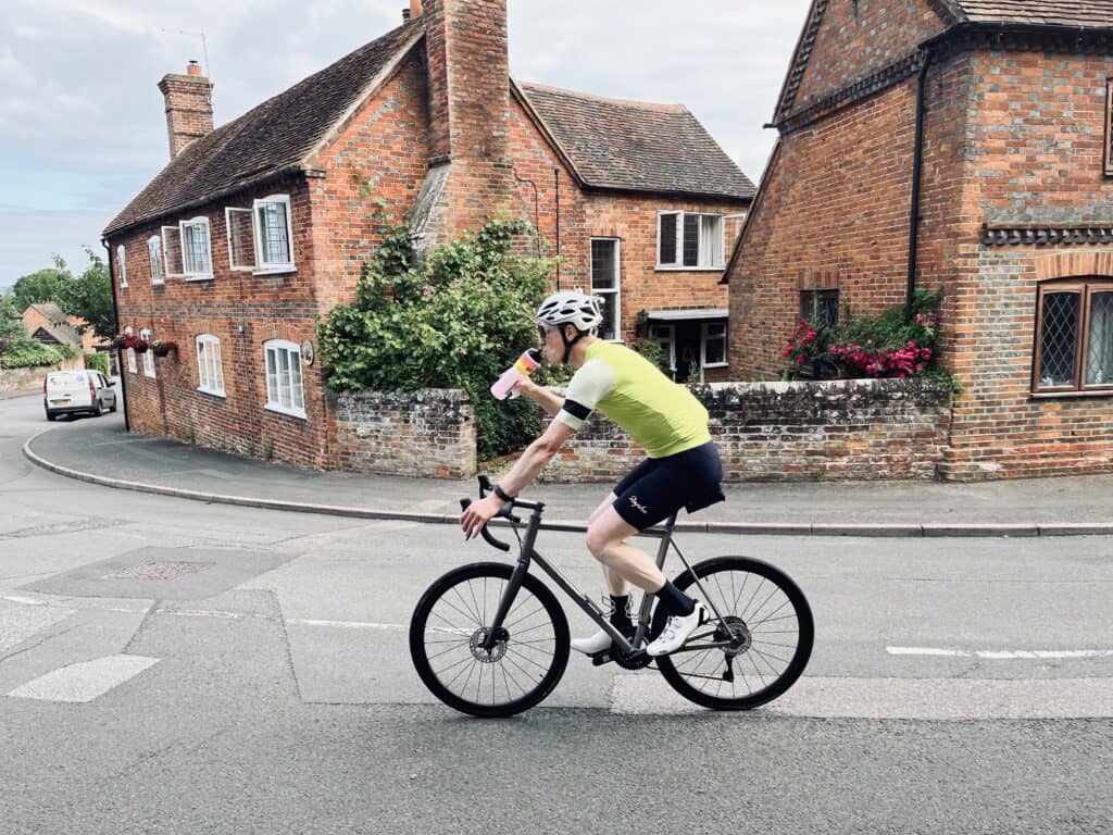 A man riding a bike down a street.